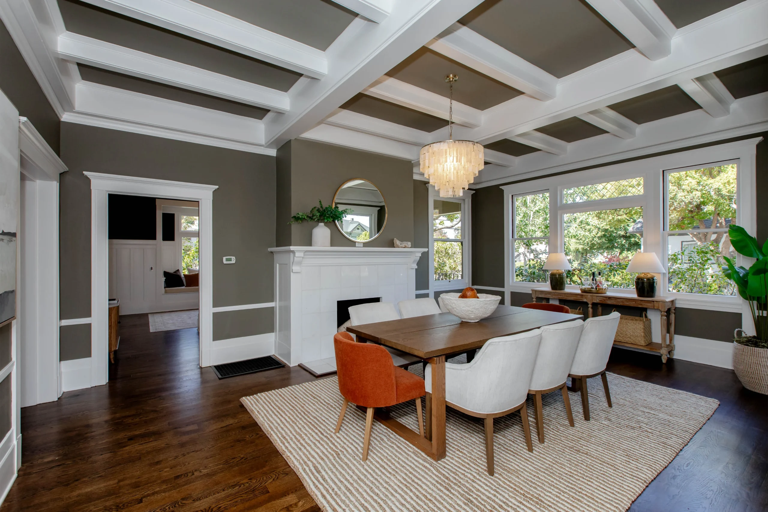Elegant dining room with large windows and modern decor.