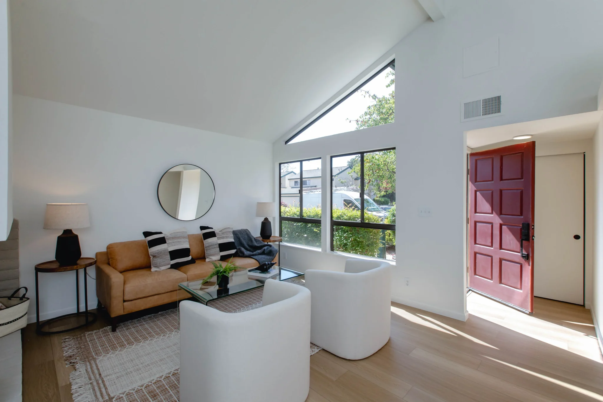 Bright living room with large windows and modern decor.