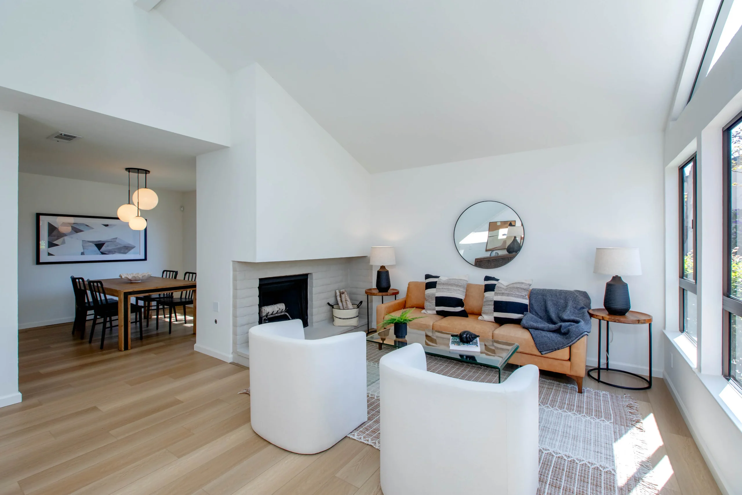 Bright living room with modern furniture and large windows.