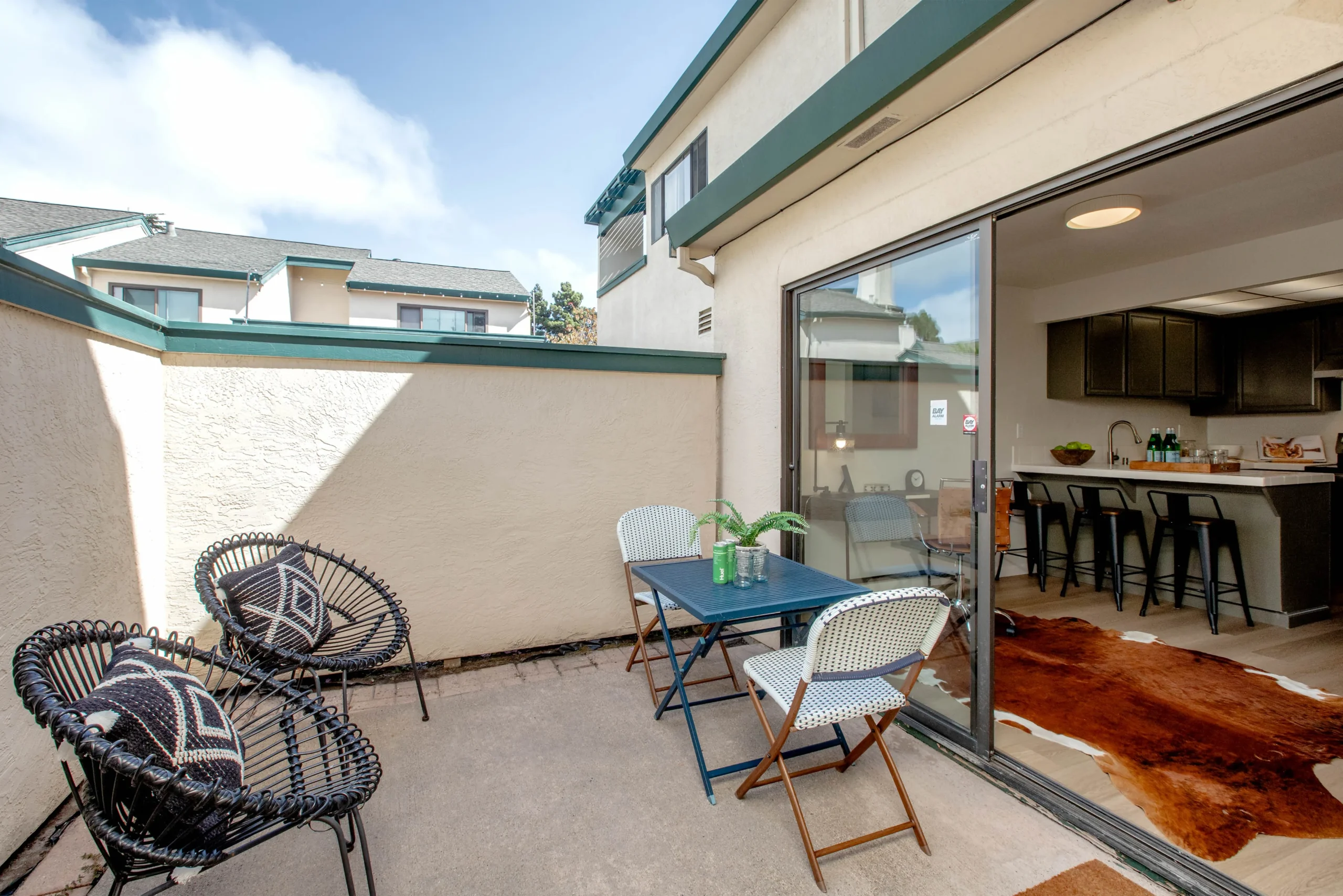 Balcony with outdoor seating overlooking a residential complex.