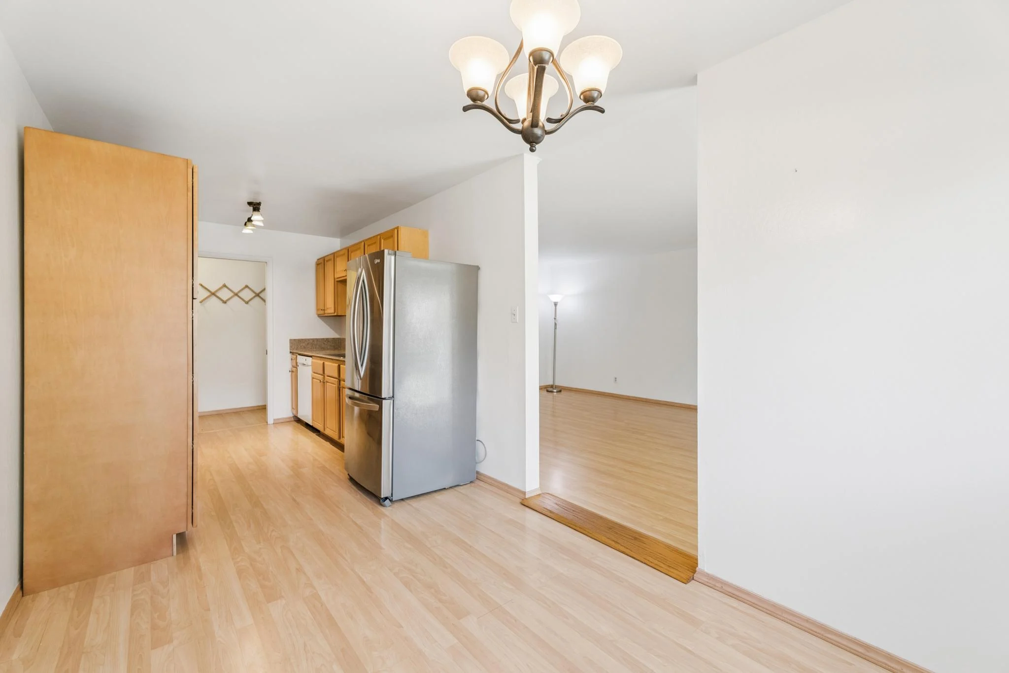 Open-concept kitchen and living area with hardwood floors and modern appliances.