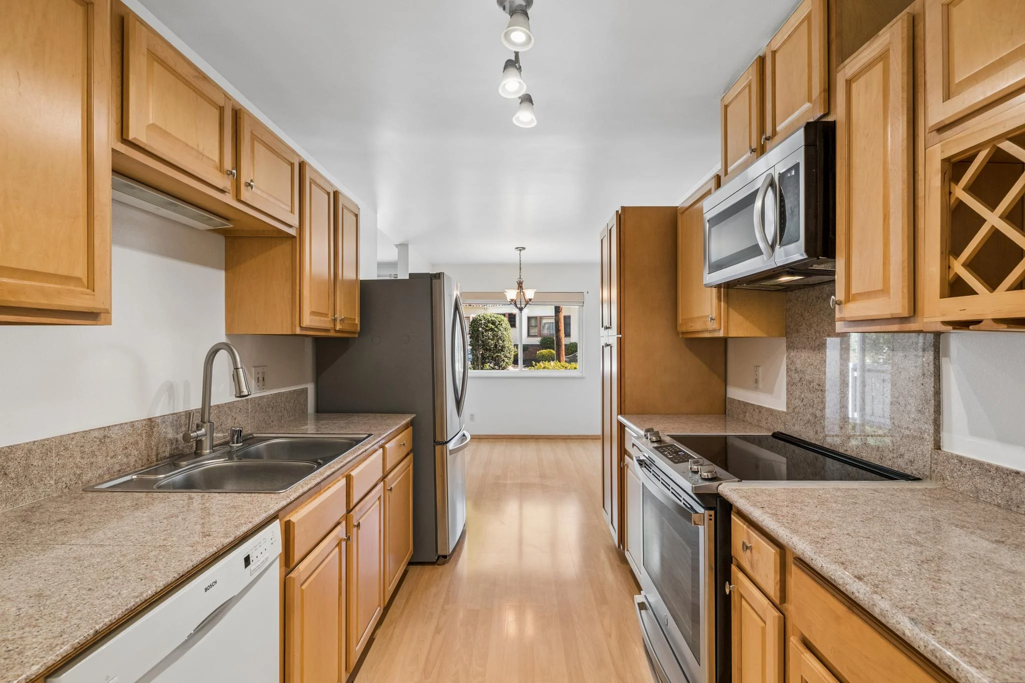 Modern kitchen with wooden cabinets and stainless steel appliances.